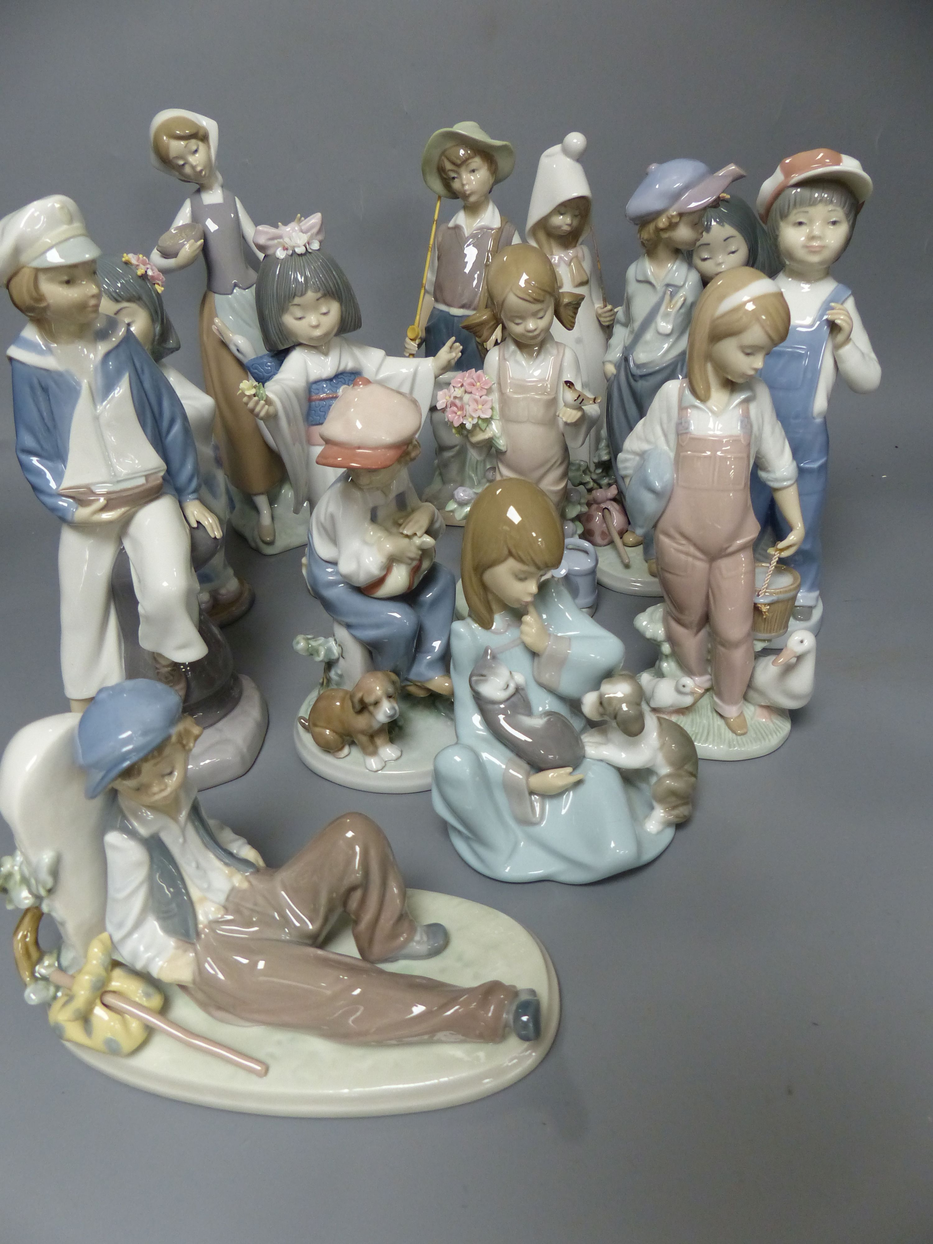 Fourteen Lladro figures of children